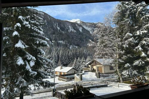 a view from a window of a snow covered mountain at Chalet Soleada - Happy Rentals in Pian San Giacomo