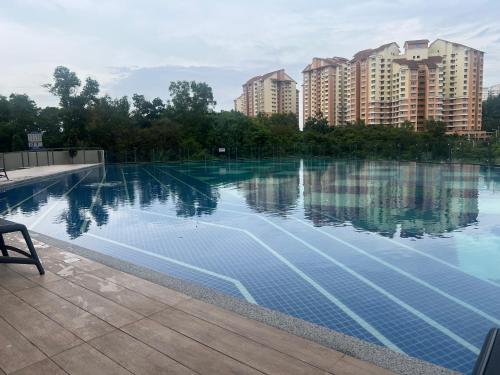 a swimming pool with buildings in the background at Aisha’s staycation big patio Putrajaya in Putrajaya