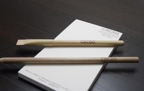 two wooden chopsticks sitting on top of white envelopes at Cacao Rooms in Ljubljana