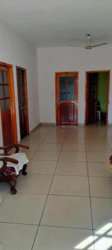 an empty room with doors and a tiled floor at Leebon's Tamil kudill in Masinagudi