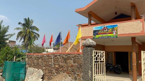 a building with flags on the side of it at Leebon's Tamil kudill in Masinagudi