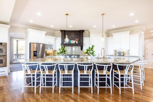 a kitchen with a large island with bar stools at Luxurious Mountain Retreat-unparalleled Views in Alpine