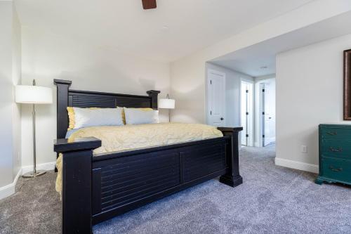 a bedroom with a black bed and a green dresser at Luxurious Mountain Retreat-unparalleled Views in Alpine
