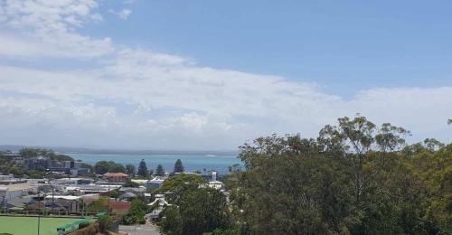 a view of a city with the ocean in the background at Casablanca Penthouse Loft - Landmark 518 in Nelson Bay