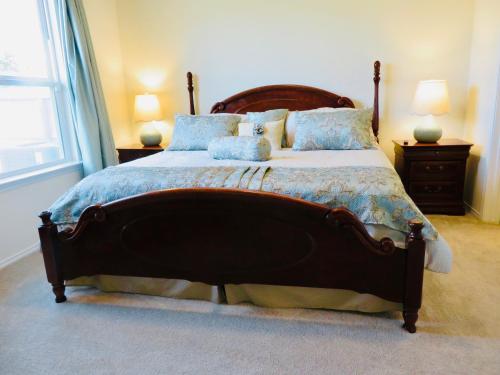 a bedroom with a large bed with blue pillows at New House family friendly near Six Flags Sea World in Helotes