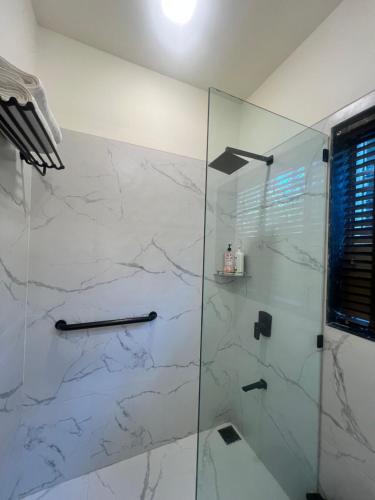 a bathroom with a shower with a glass door at Villa by the Sea in Mumbai