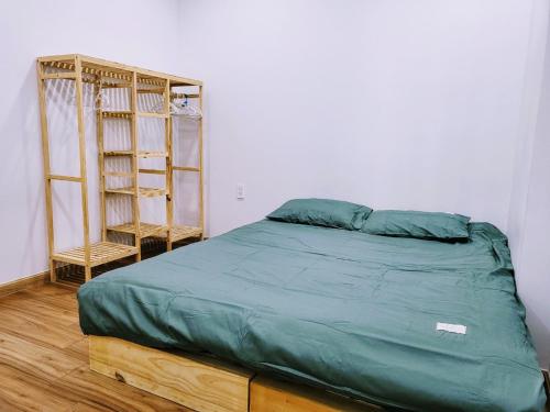 a bedroom with a bed and a book shelf at Bcons Garden Luxury Aparment in Dĩ An