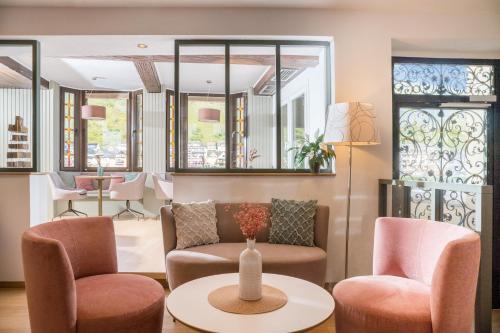 a living room with two chairs and a table at Hotel Weinhof in Cochem