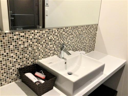 a bathroom with a white sink and a mirror at THE VIEW Odawara shiro-no mieru hotel - Vacation STAY 63560v in Odawara