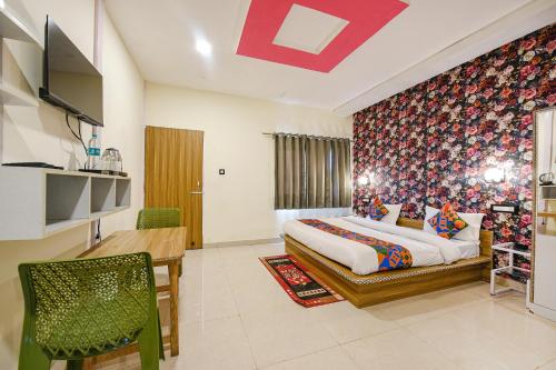 a bedroom with a bed and a dining room at FabHotel Sizzling Resort & Adventure in Dhanaulti