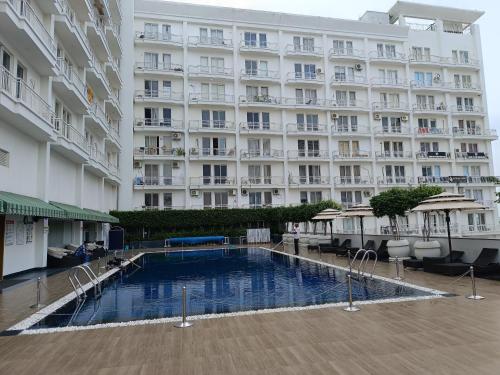 a large building with a swimming pool in front of it at The Awadh Retreat in Lucknow