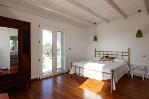 um quarto com uma cama e piso em madeira em Sunny House Trilo with Pool - Happy Rentals em Sanarica