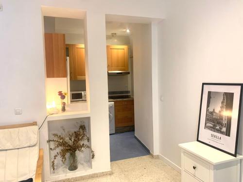 a kitchen with white walls and a room with at Sevilla Central in Seville