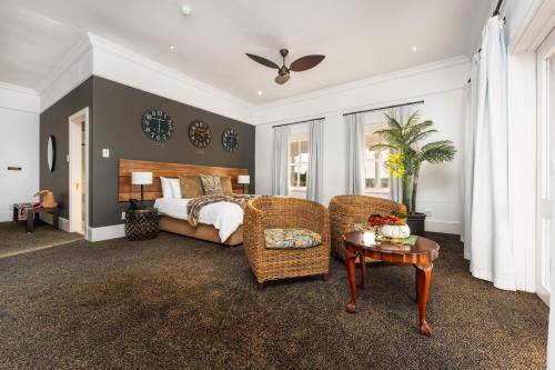 a bedroom with a bed and a table and chairs at Prince's Grant Coastal Golf Estate - The Lodge in Blythedale