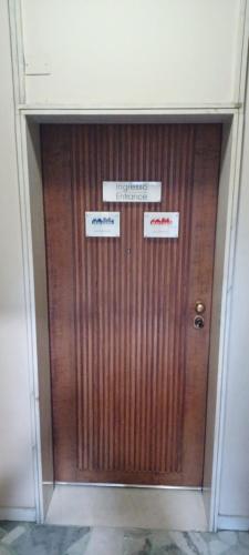 a large wooden door with signs on it at Marcona24 in Milan