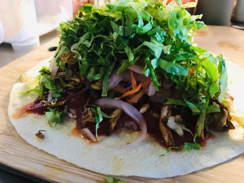 a salad on top of a tortilla on a cutting board at Chillax Inn B&B 恆春鬆塊民宿 in Hengchun