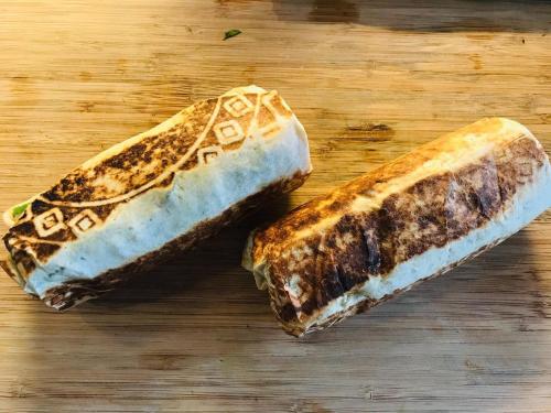twoasted sandwiches sitting on a wooden cutting board at Chillax Inn B&B 恆春鬆塊民宿 in Hengchun