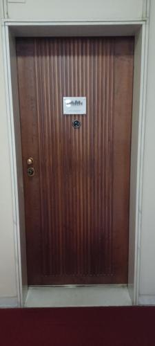 a large wooden door with a sign on it at Marcona24 in Milan