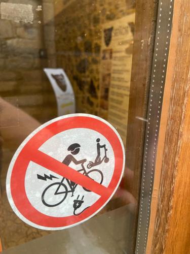a sign on a window with a person on a bike at SEÑOR OSO in Molinaseca