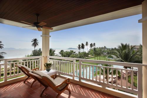 a balcony with chairs and a view of the ocean at Sofitel Krabi Phokeethra Golf and Spa Resort in Klong Muang Beach