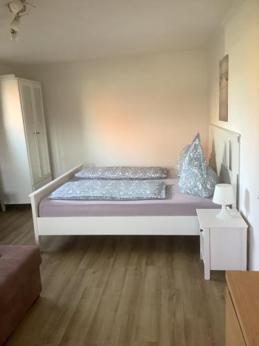 a large bed in a room with wooden floors at Ferienwohnung 3 in Dahme