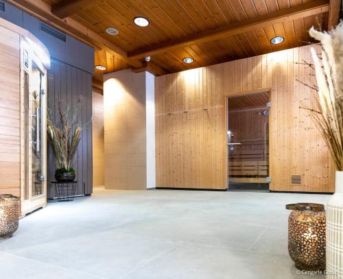 a lobby with wood paneled walls and concrete floors at Bergresort Gerlitzen by ALPS RESORTS in Treffen