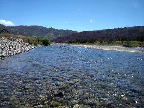 a river with rocks in the water at Birdsong Alley Bed and Breakfast in Hanmer Springs