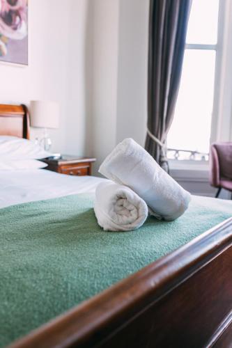 a towel sitting on top of a bed at The Nines in Bangor
