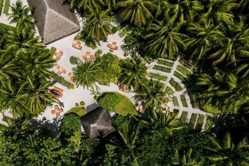 an aerial view of a resort with palm trees at One&Only Reethi Rah in Reethi Rah