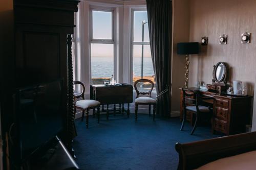 a room with a table and chairs and a window at The Nines in Bangor
