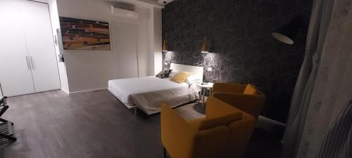 a bedroom with a bed and a table and chairs at Marcona24 in Milan