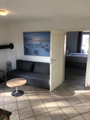 a living room with a couch and a table and a bed at Pension Villa Wolkenlos in Dahme