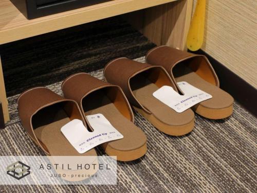 two pairs of brown shoes sitting on the floor at Astil Hotel Juso Precious - Vacation STAY 16022v in Osaka
