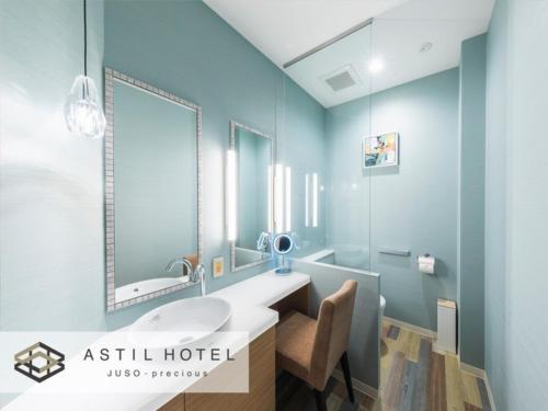 a bathroom with a sink and a mirror at Astil Hotel Juso Precious - Vacation STAY 16022v in Osaka