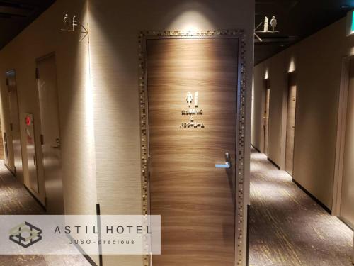 a wooden door in a building with a sign on it at Astil Hotel Juso Precious - Vacation STAY 16022v in Osaka