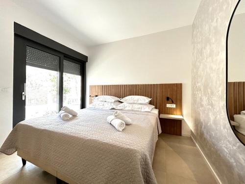 a bedroom with a bed with two towels on it at Sandi Hvar Apartments in Hvar