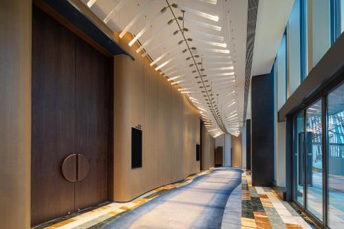 a hallway in a building with a row of lights at Hotel Indigo Wuxi Taihu New City in Wuxi