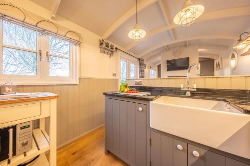 a kitchen with a large sink and a counter at Barleywood in South Creake