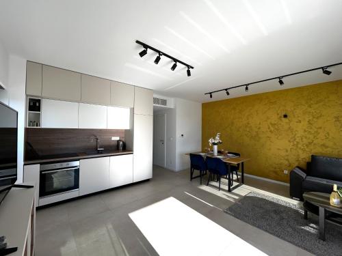 a kitchen and living room with a couch and a table at Sandi Hvar Apartments in Hvar