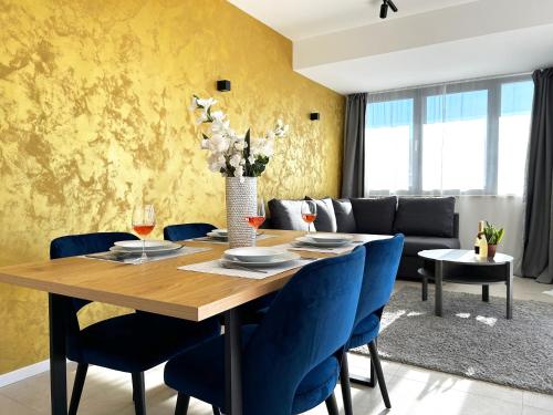 a dining room with a wooden table and blue chairs at Sandi Hvar Apartments in Hvar