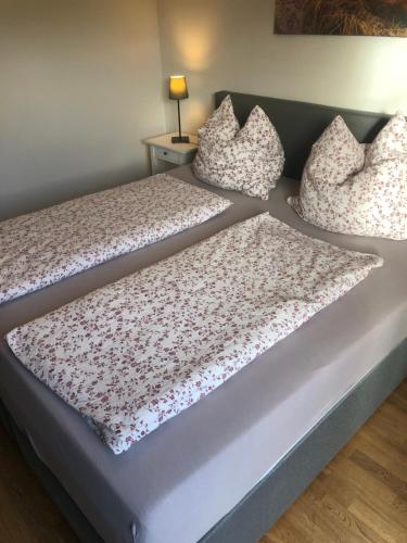 a bed with two pillows on top of it at Pension Villa Wolkenlos in Dahme