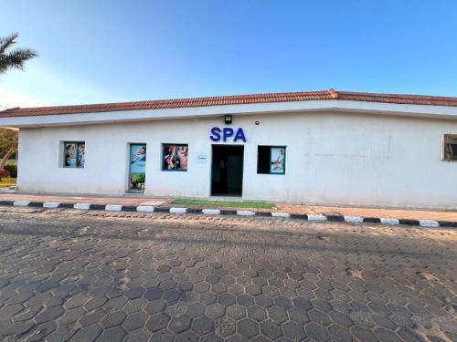 a white building with a spa sign on it at Sharm Cliff Hotel in Sharm El Sheikh