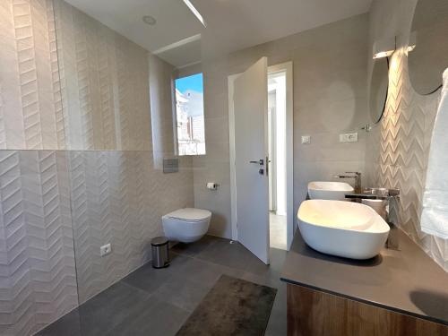 a bathroom with two toilets and a sink at Sandi Hvar Apartments in Hvar
