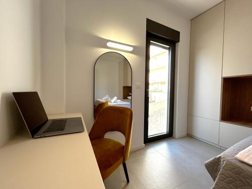 a room with a desk with a laptop and a chair at Sandi Hvar Apartments in Hvar