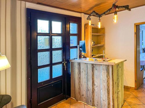 a kitchen with a door and a counter with a sink at Pension "Zur Lohgerberei" in Bad Langensalza