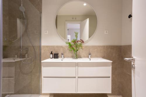 a bathroom with a white sink and a mirror at San Bernardo - Darya Living in Madrid