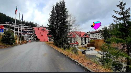 a kite flying in the air over a street at Apartment 9 in Pamporovo