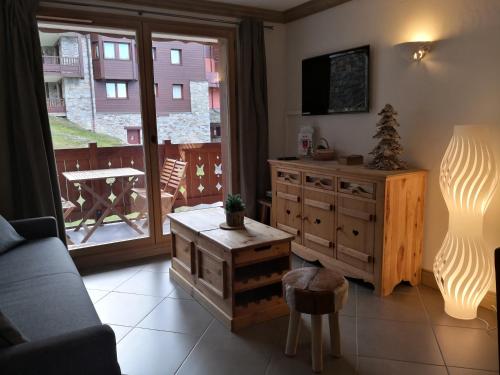 a living room with a couch and a table at les 7 laux immobilier chalet D in Prapoutel