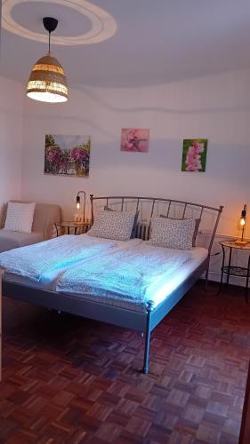 a large bed in a room with a couch at Penzión Vilka Podhájčanka in Podhájska