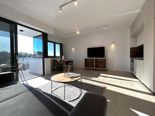 a living room with a couch and a table at Sandi Hvar Apartments in Hvar